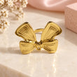 18K gold plated bow statement ring for women on luxury cream background – TVAYI