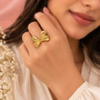 Woman wearing 18K gold plated bow statement ring by TVAYI
