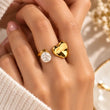 Amora Heart and Pearl Ring detailed close-up showing polished gold heart pearl accent and adjustable band