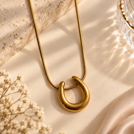 Aurevia 18K Gold Plated Sculpted Pendant Necklace on premium cream background – TVAYI