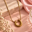 Aurevia Gold Plated Pendant Necklace for Women on luxury pink background – TVAYI