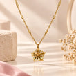 TVAYI Aurora Bloom 18K gold plated floral necklace on a premium cream background