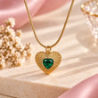 18K gold plated green heart pendant necklace on a luxury cream and baby pink background