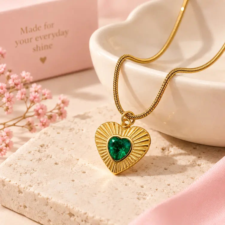 Slide 2:
Close-up of 18K gold plated green heart pendant necklace showing the detailed gold setting and green gemstone