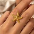 lose-up of Marina 18K Gold Plated Starfish Ring worn on finger – TVAYI