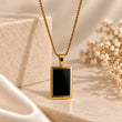 Noiré 18K Gold Plated Black Rectangular Pendant Necklace on premium cream background – TVAYI