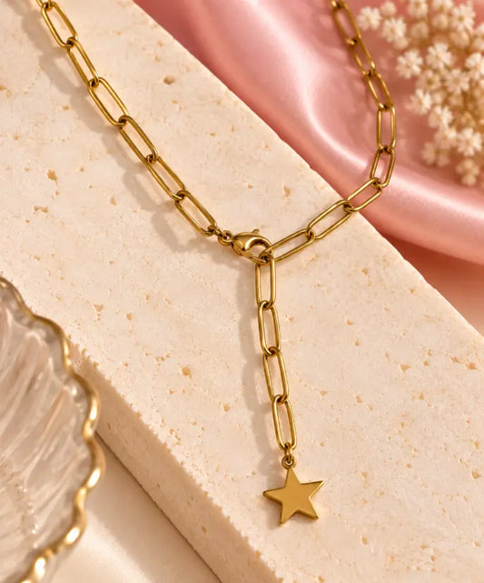 18K gold plated Celeste Star Drop Necklace on premium cream background