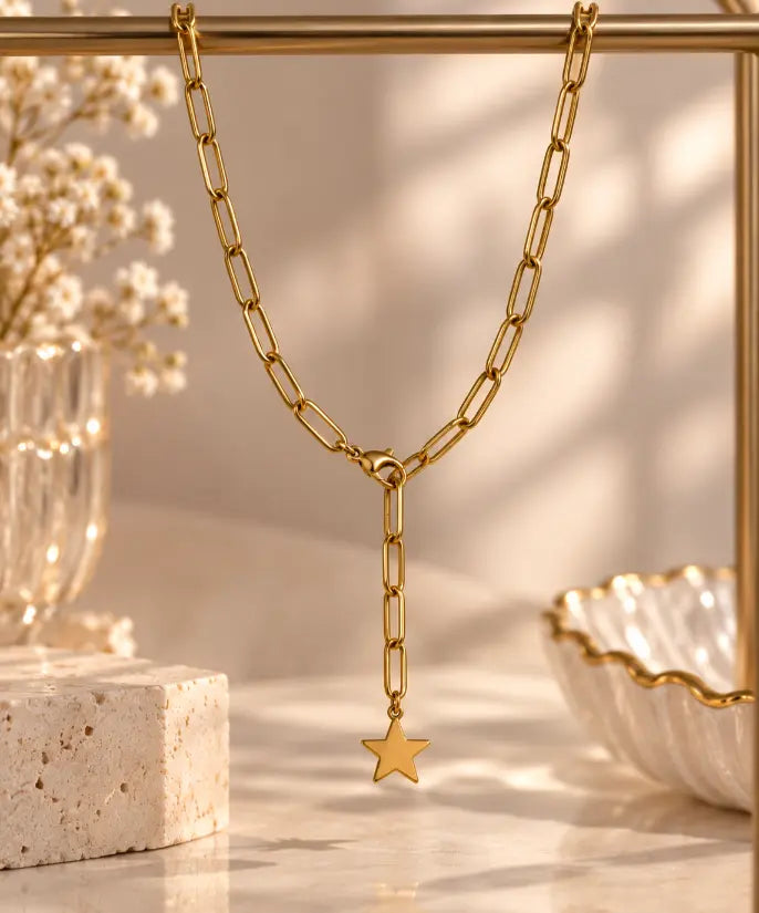 Close-up of 18K gold plated paperclip chain and plain gold star pendant