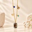 18K gold plated Celeste Star Drop Necklace on premium cream background