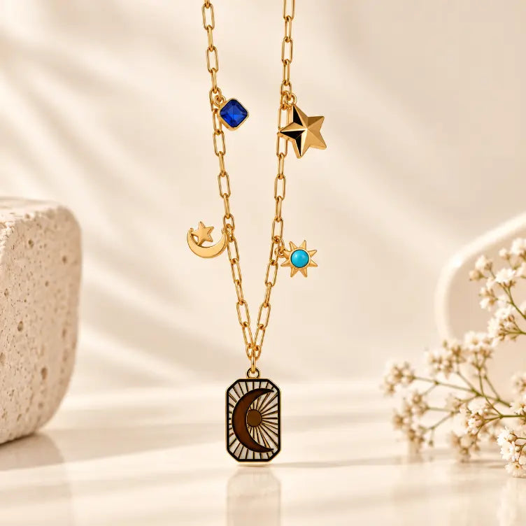 18K gold plated Celeste Star Drop Necklace on premium cream background