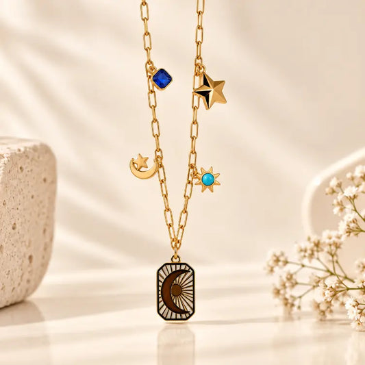 18K gold plated Celeste Star Drop Necklace on premium cream background