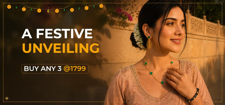 A promotional banner with the text 'A FESTIVE UNVEILING' and 'BUY ANY 3 @1799' alongside a woman wearing a beige embroidered top and a green beaded necklace, set against a warm, softly lit background with string lights.